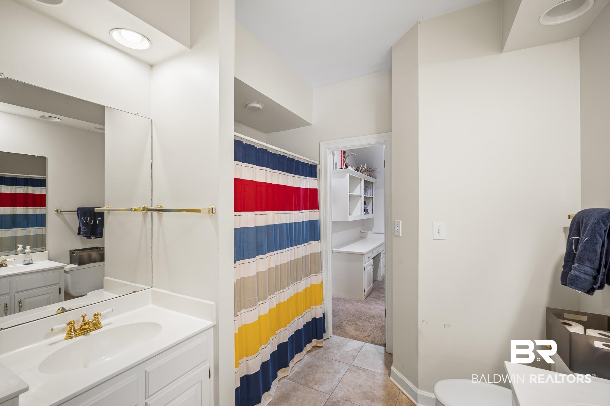 402 Potters Mills Road Daphne, AL 36526 - Photo 33 of 45 Bathroom featuring tile patterned flooring, vanity, toilet, and a shower with shower curtain