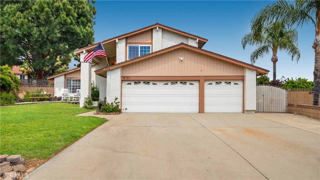6721 Teak Way Rancho Cucamonga, CA 91701 - Photo 1 of 1 a front view of a house with a yard and garage