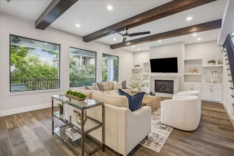 a living room with fireplace furniture and a flat screen tv