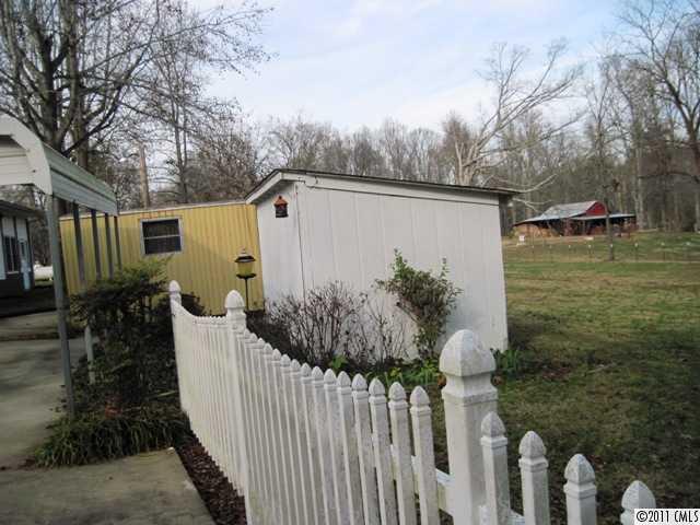 1410 Requa Road Cherryville, NC 28021 - Photo 12 of 16 a view of a house with a small yard and wooden fence