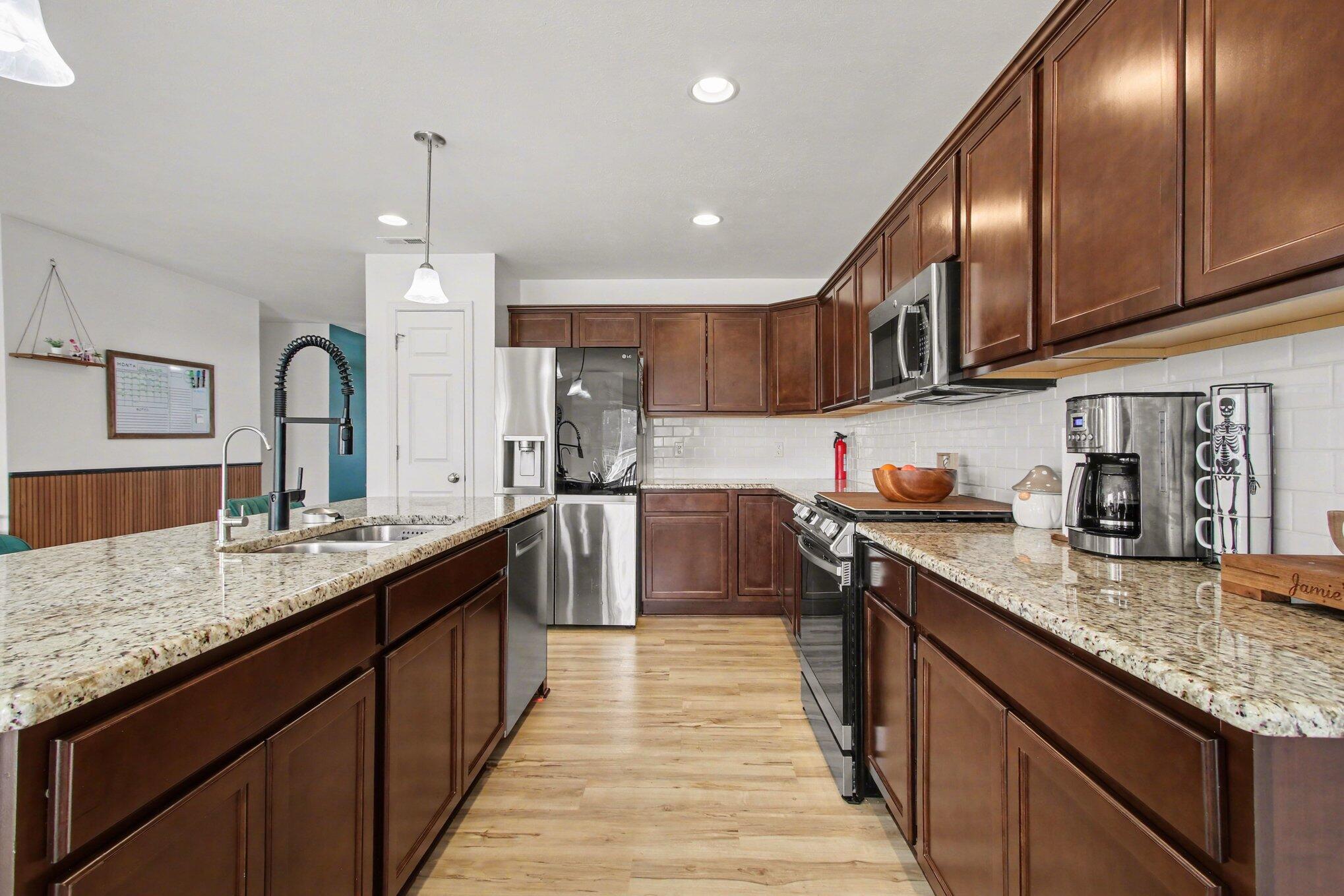 15549 West 101st Place Dyer, IN 46311 - Photo 7 of 14 a open kitchen with stainless steel appliances granite countertop a sink stove and cabinets