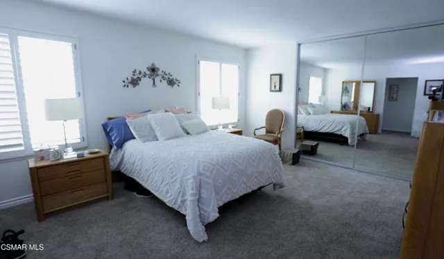 a spacious bedroom with a bed and a couch