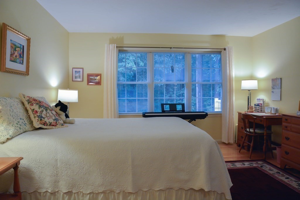 39 Riley Road, Unit 51 Lunenburg, MA 01462 - Photo 14 of 42 a bedroom with a large bed and a dresser