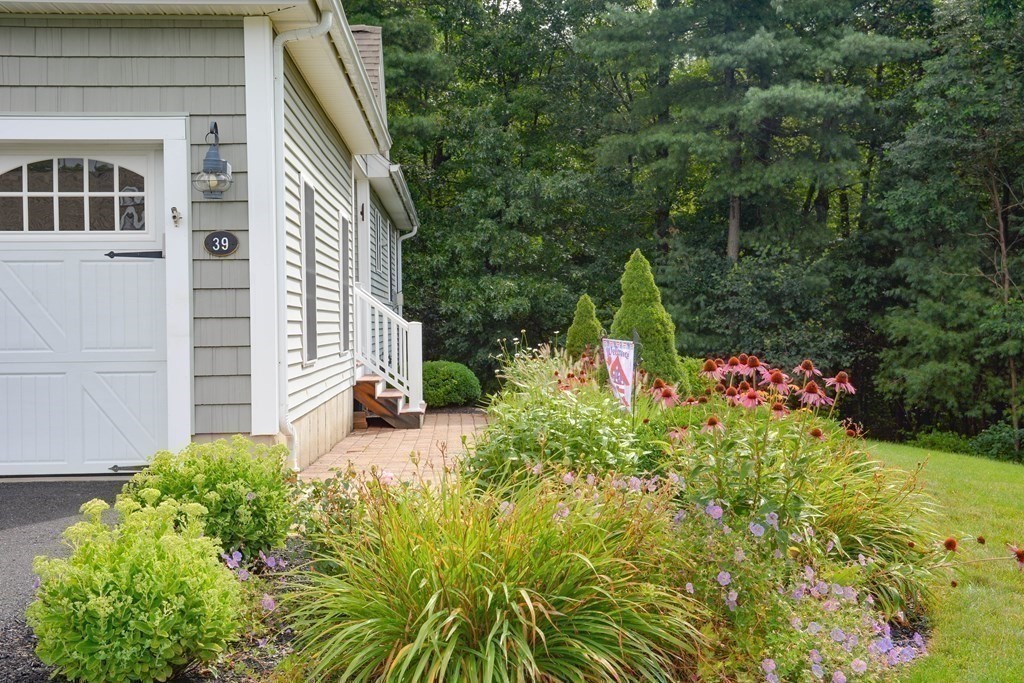 39 Riley Road, Unit 51 Lunenburg, MA 01462 - Photo 38 of 42 a view of a house with a yard and garden