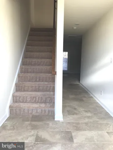 a view of staircase with white walls