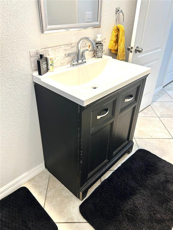 13809 Felix Will Road Riverview, FL 33579 - Photo 14 of 75 a bathroom with a sink and a mirror