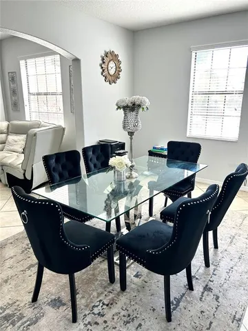 a kitchen with stainless steel appliances granite countertop a refrigerator a sink a stove and a wooden floors