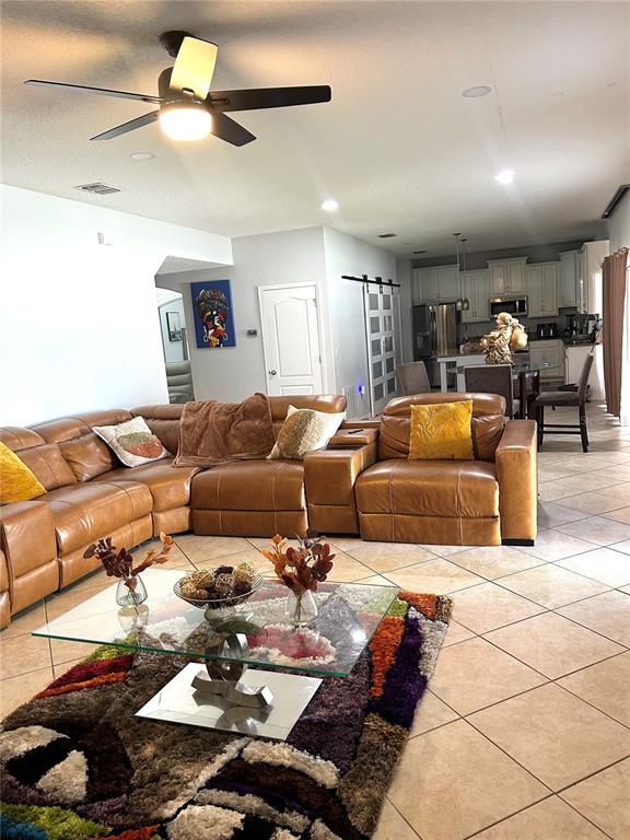 13809 Felix Will Road Riverview, FL 33579 - Photo 17 of 75 a living room with furniture and a rug