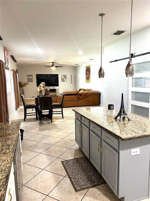 13809 Felix Will Road Riverview, FL 33579 - Photo 18 of 75 a kitchen with stainless steel appliances kitchen island granite countertop a sink a counter top space and cabinets