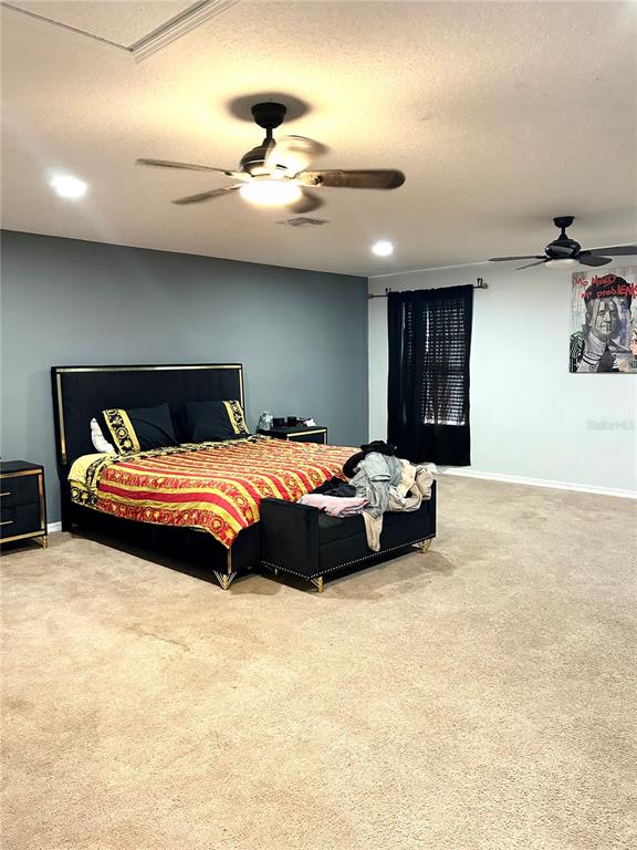 13809 Felix Will Road Riverview, FL 33579 - Photo 31 of 75 a bedroom with a bed and a ceiling fan