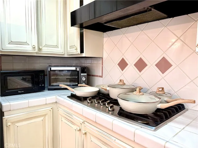 a kitchen with a sink a stove and a microwave