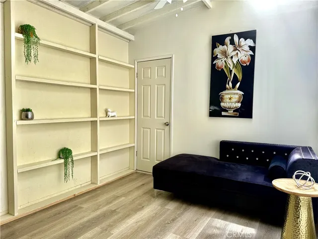 a bedroom with a bed and a painting on the wall