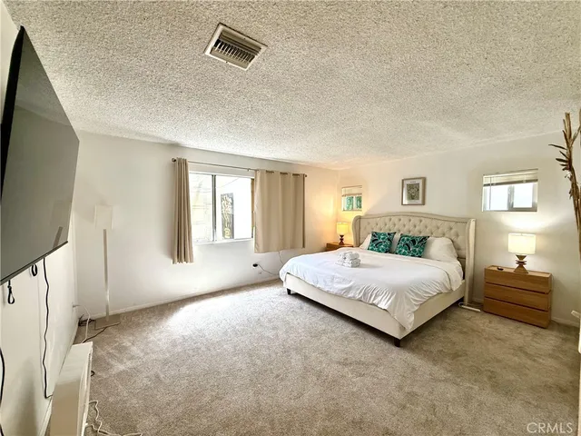 a living room with a bed furniture and a flat screen tv