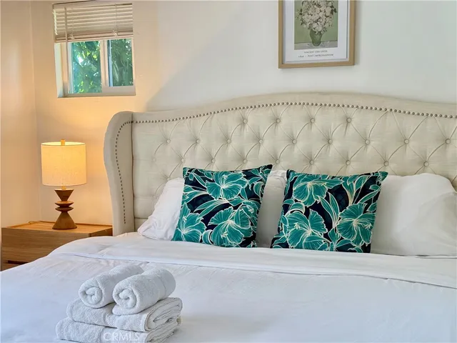 a bedroom with a bed and a window