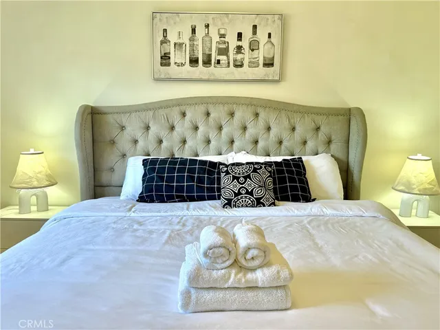 a bedroom with a bed and lamp