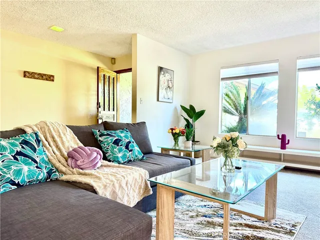 a bedroom with a bed mirror and couch