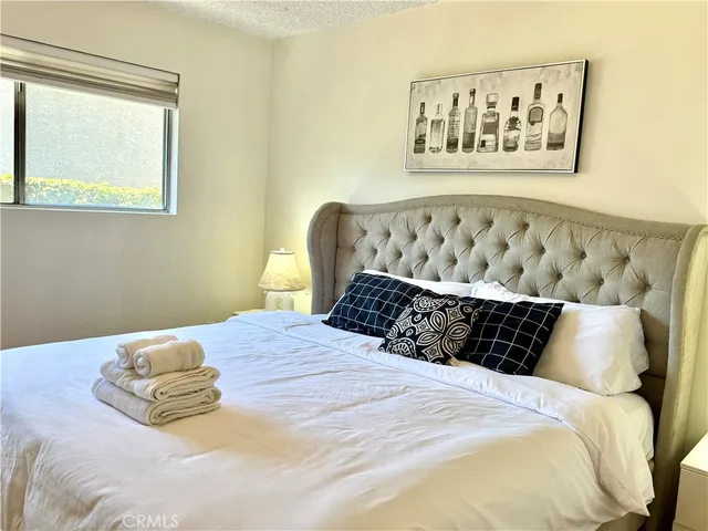 a bed sitting in a bedroom next to a window