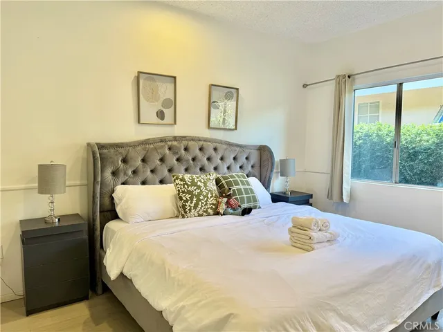 a bedroom with a large bed and a lamp