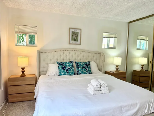 a bedroom with a bed and a lamp