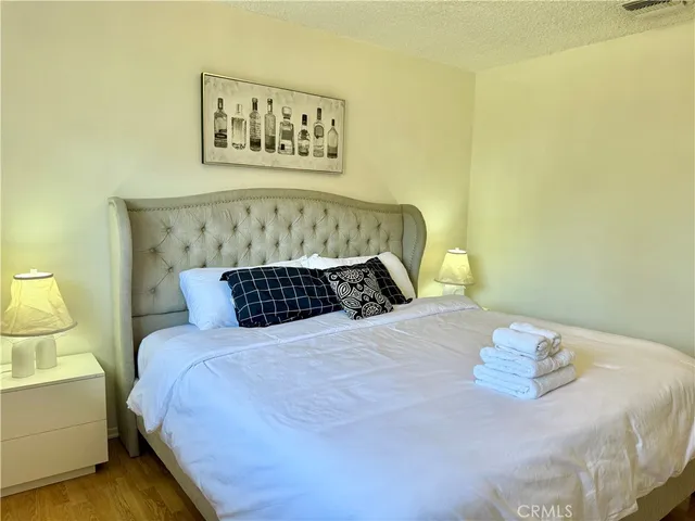 a bedroom with a bed and lamp