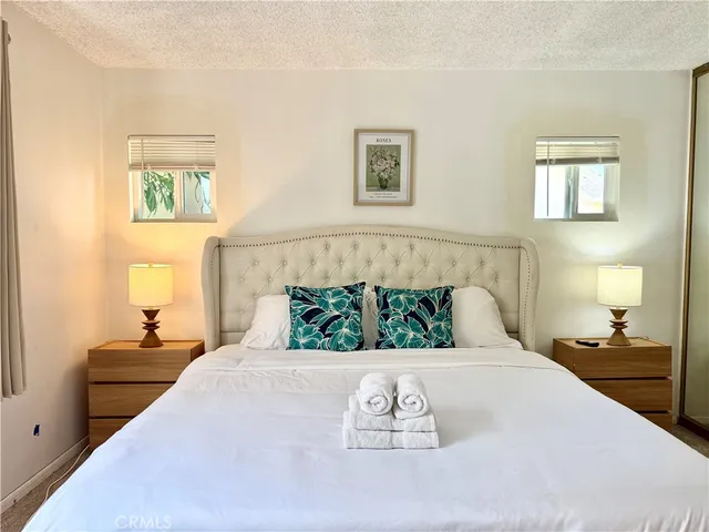 a bedroom with a large bed and a window