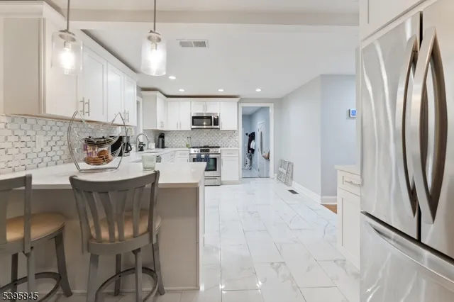 a kitchen with refrigerator and cabinets
