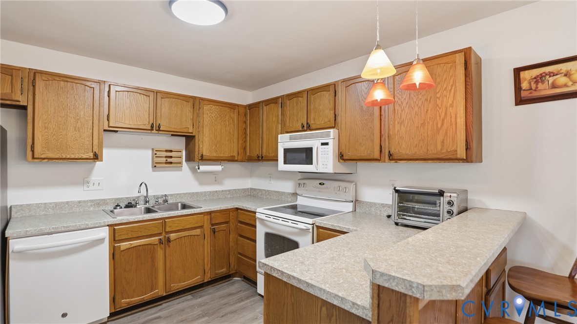 408 Springdale Avenue Colonial Heights, VA 23834 - Photo 14 of 49 Kitchen with white appliances, a peninsula, pendan