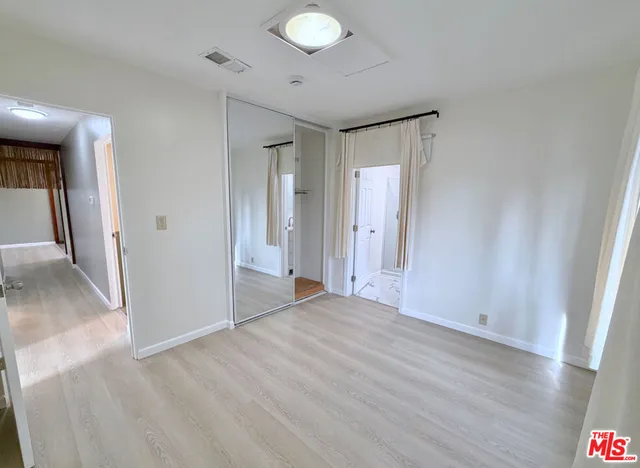 a kitchen with a refrigerator and a stove top oven