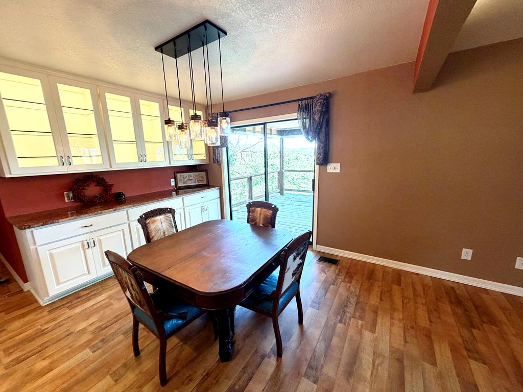 707 Rimrock Road Kerrville, TX 78028 - Photo 23 of 55 a view of a dining room with furniture window and wooden floor