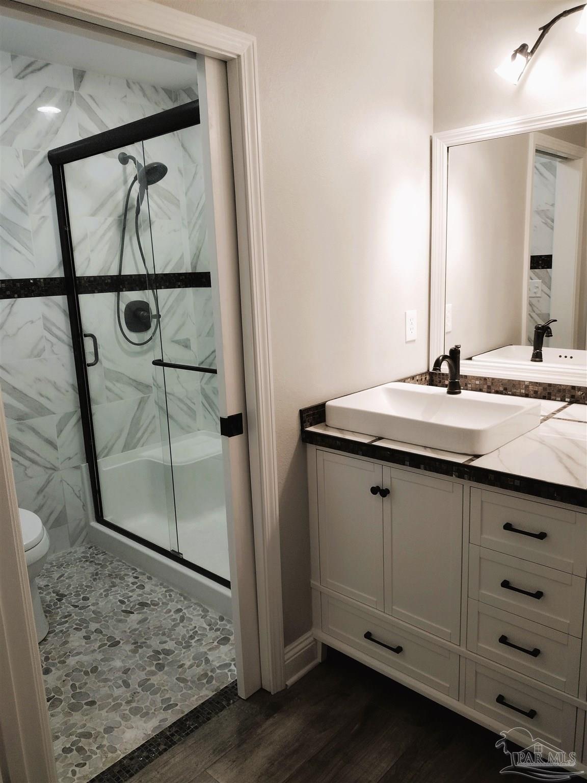 4611 Gunter Road Milton, FL 32570 - Photo 12 of 29 a bathroom with a granite countertop sink a mirror and shower