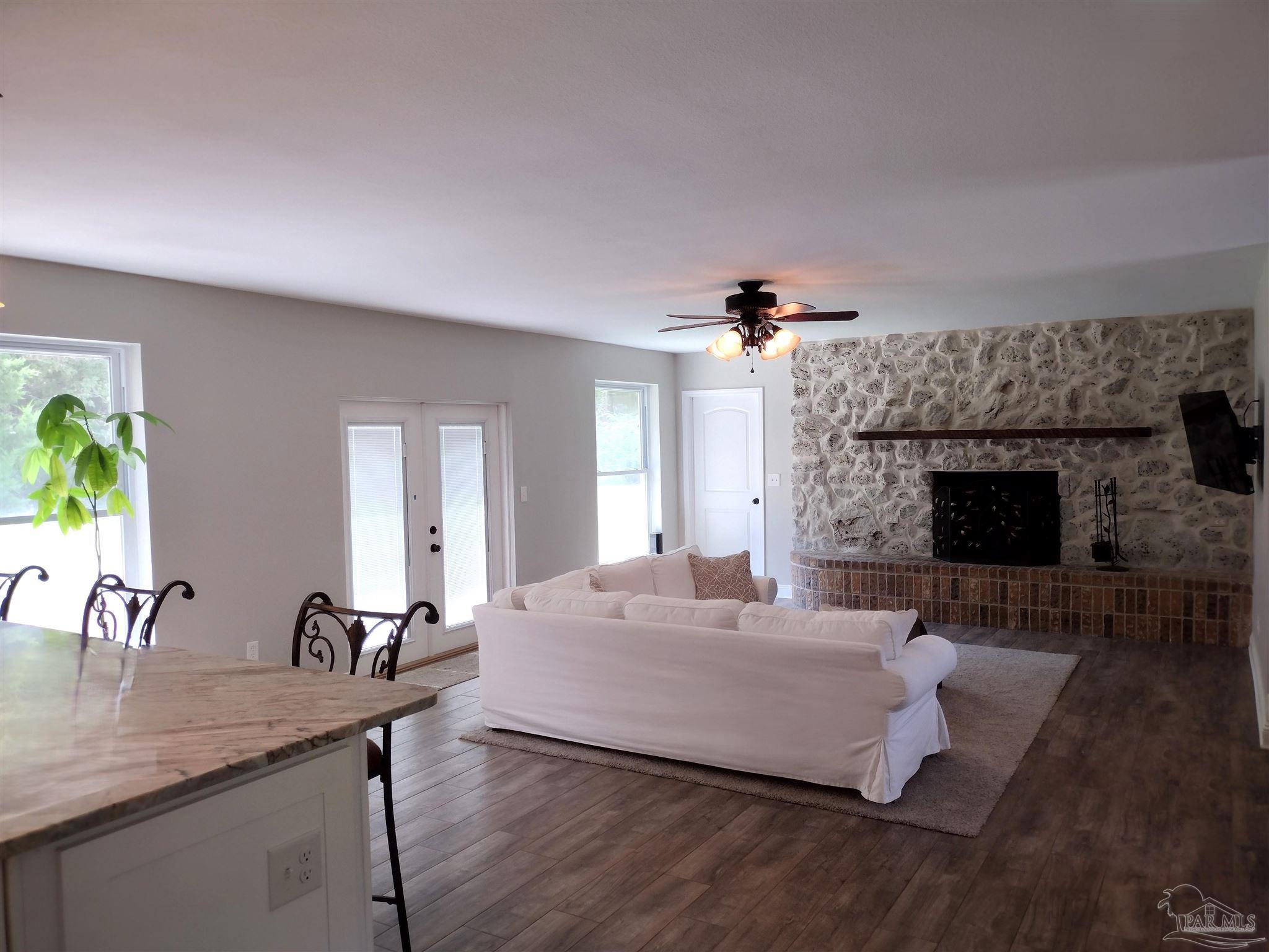 4611 Gunter Road Milton, FL 32570 - Photo 8 of 29 a living room with furniture and a fireplace