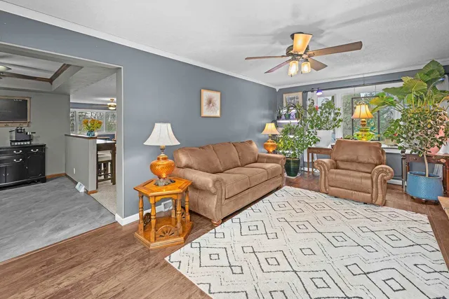 a living room with furniture and a chandelier