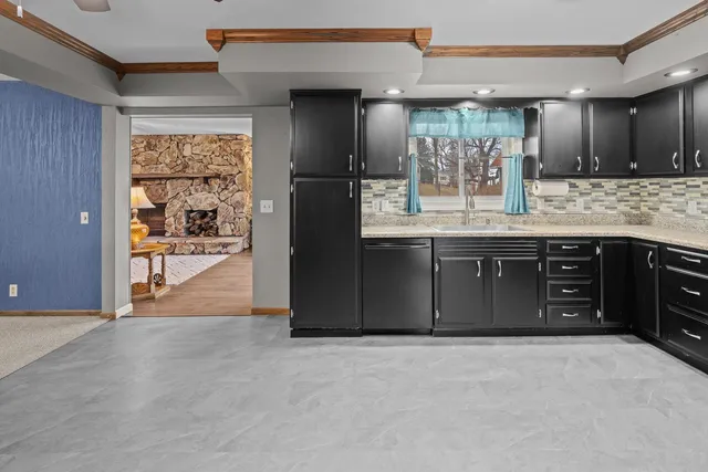 a view of a kitchen with a sink and a window