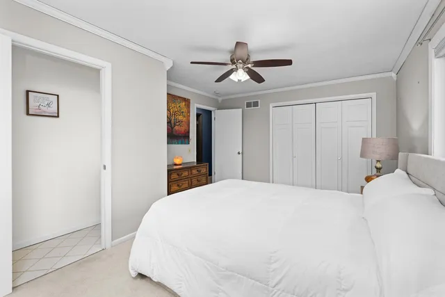 a bedroom with a bed and a large mirror