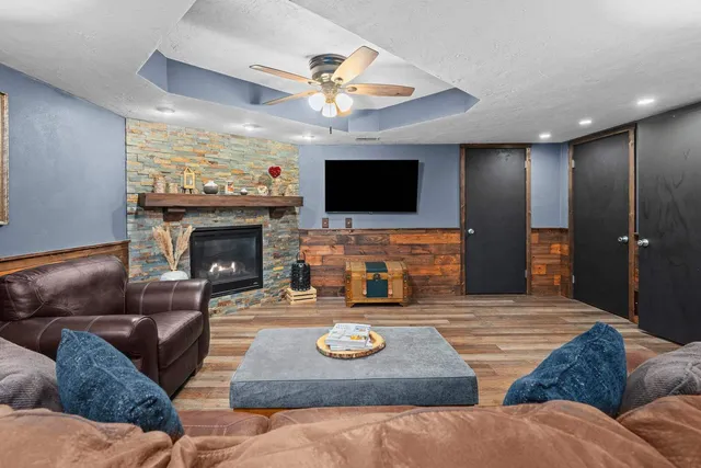 a living room with furniture a flat screen tv and a fireplace