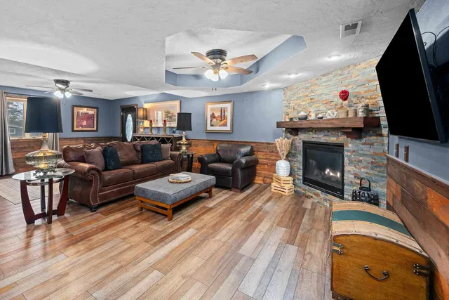a living room with furniture a fireplace and a flat screen tv