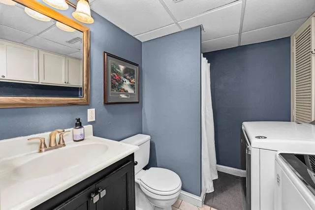 a bathroom with a sink a toilet and a mirror