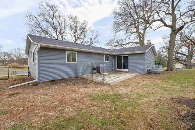 a view of a house with a yard covered in snow