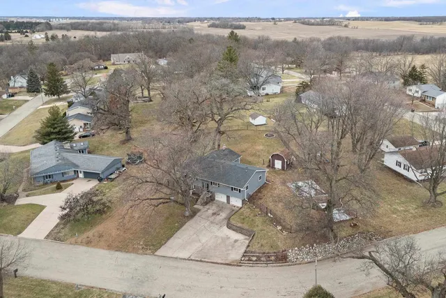 an aerial view of a house with a yard