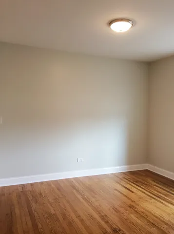 a view of an empty room and wooden floor
