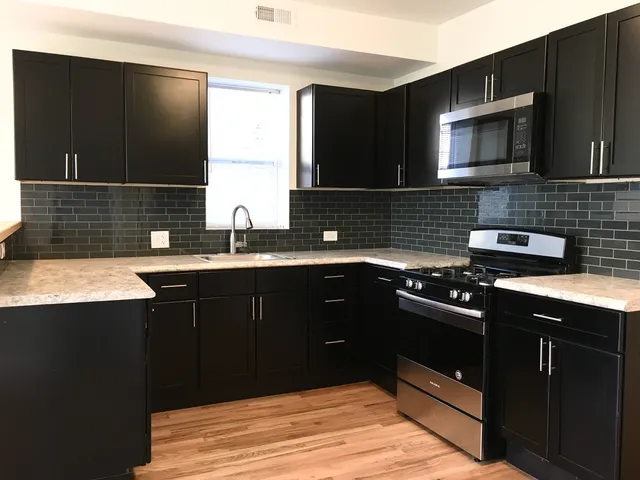 a kitchen with a sink stove and microwave