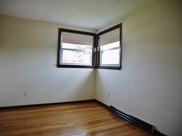 191 Hardy Pond Road Waltham, MA 02451 - Photo 11 of 16 an empty room with wooden floor and windows