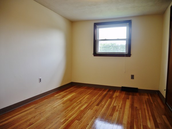 191 Hardy Pond Road Waltham, MA 02451 - Photo 5 of 16 an empty room with wooden floor and windows