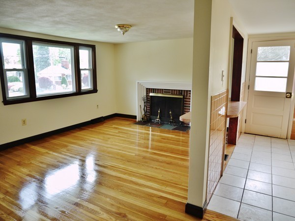 191 Hardy Pond Road Waltham, MA 02451 - Photo 7 of 16 a view of an empty room with a fireplace and a window