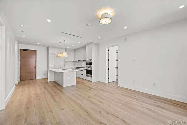 a view of kitchen with wooden floor and electronic appliances