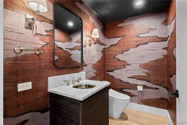 a bathroom with a sink a toilet and mirror