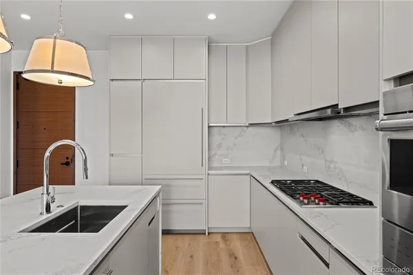 a kitchen with a sink cabinets and appliances