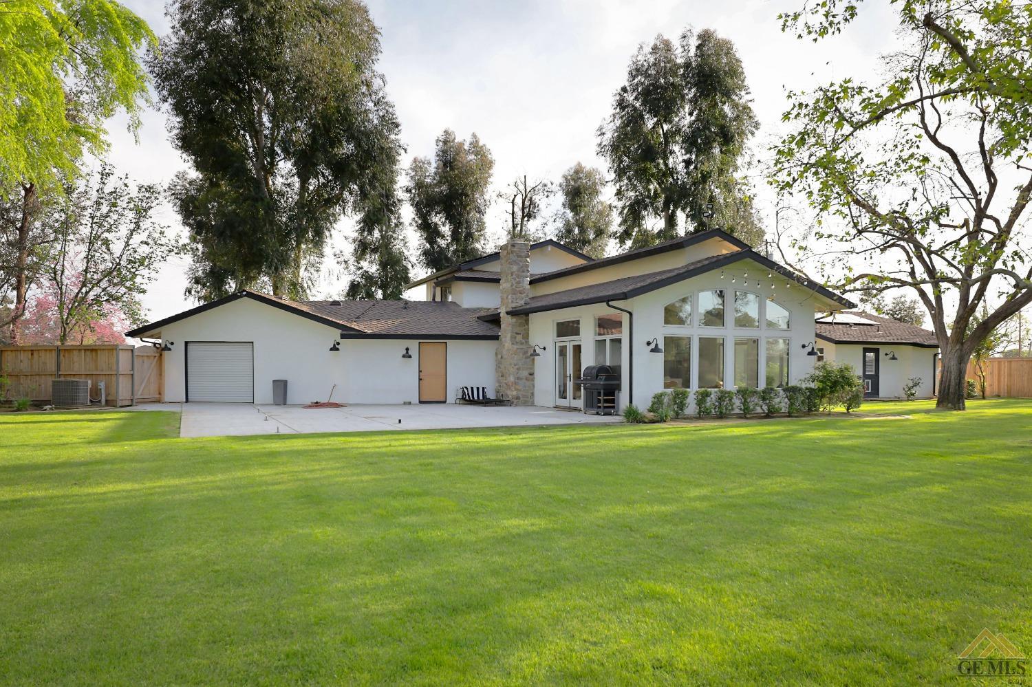 Undisclosed Address Bakersfield, CA 93314 - Photo 30 of 52 a front view of a house with a yard and trees
