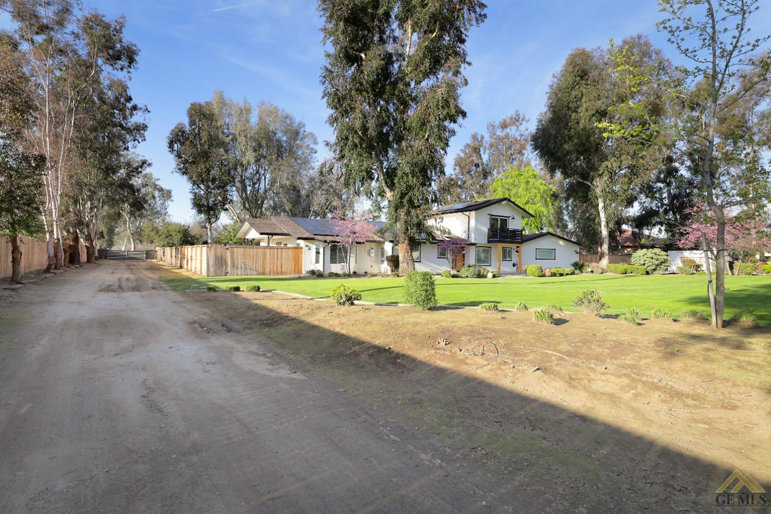 Undisclosed Address Bakersfield, CA 93314 - Photo 46 of 52 a view of a house with a yard and large tree