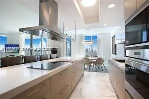 a large kitchen with a table and chairs